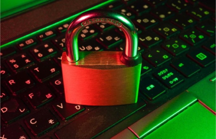A secure lock sitting on a laptop keyboard, symbolizing the importance of data security.